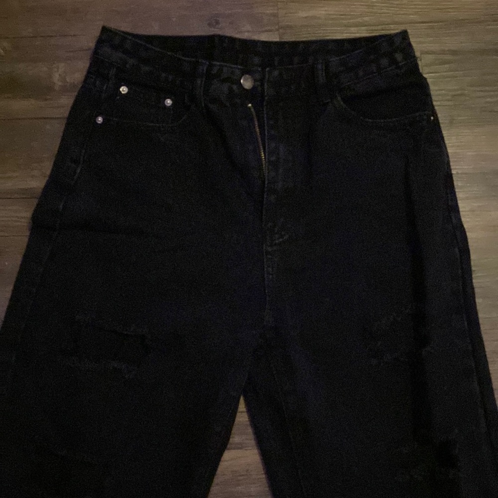 Woman’s black ripped jeans